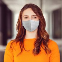 Woman wearing Martex Health grey striped reusable face mask with antimicrobial protection.