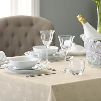 Linen tablecloth with the table set for dinner